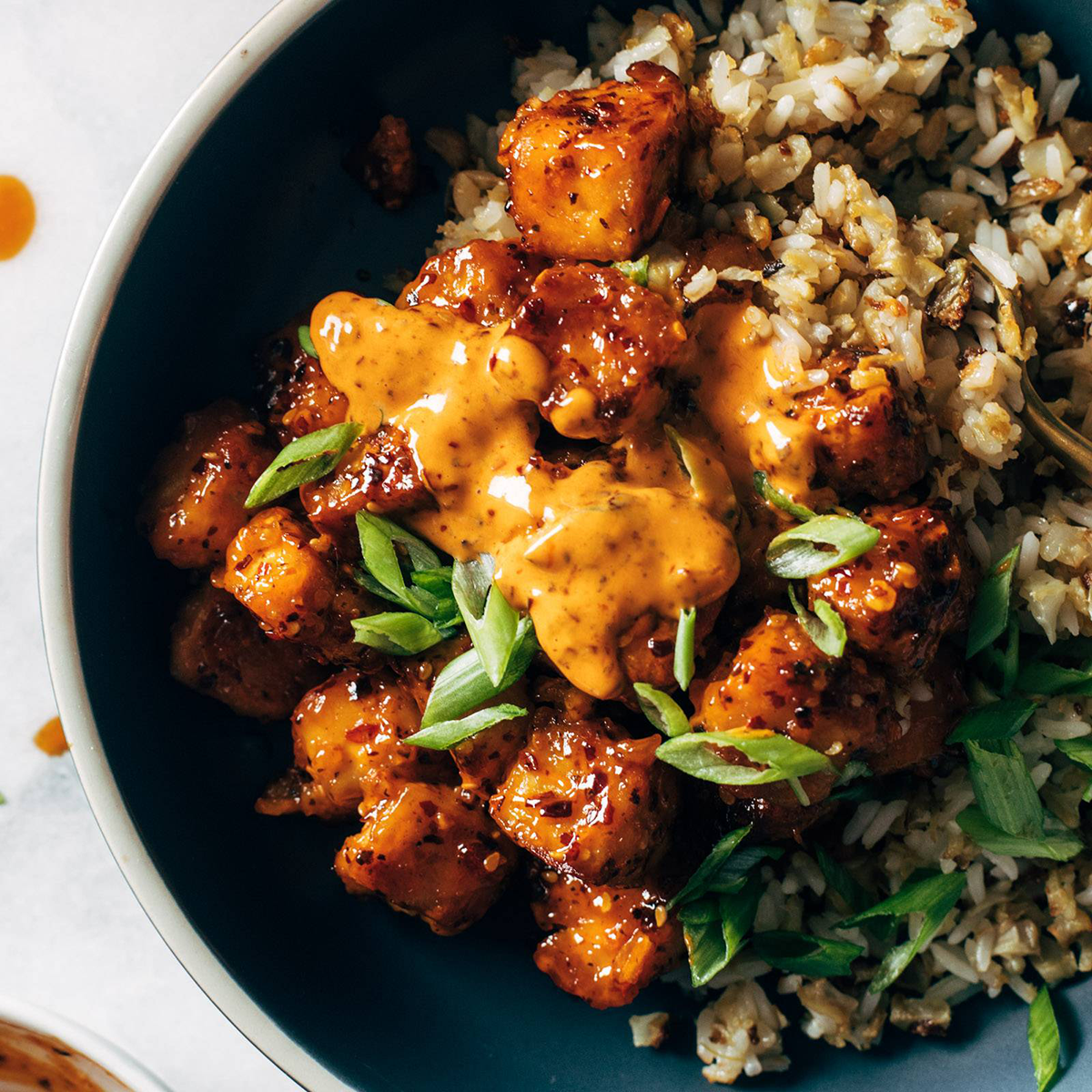 Chili crunch tofu in a bowl with rice mix.