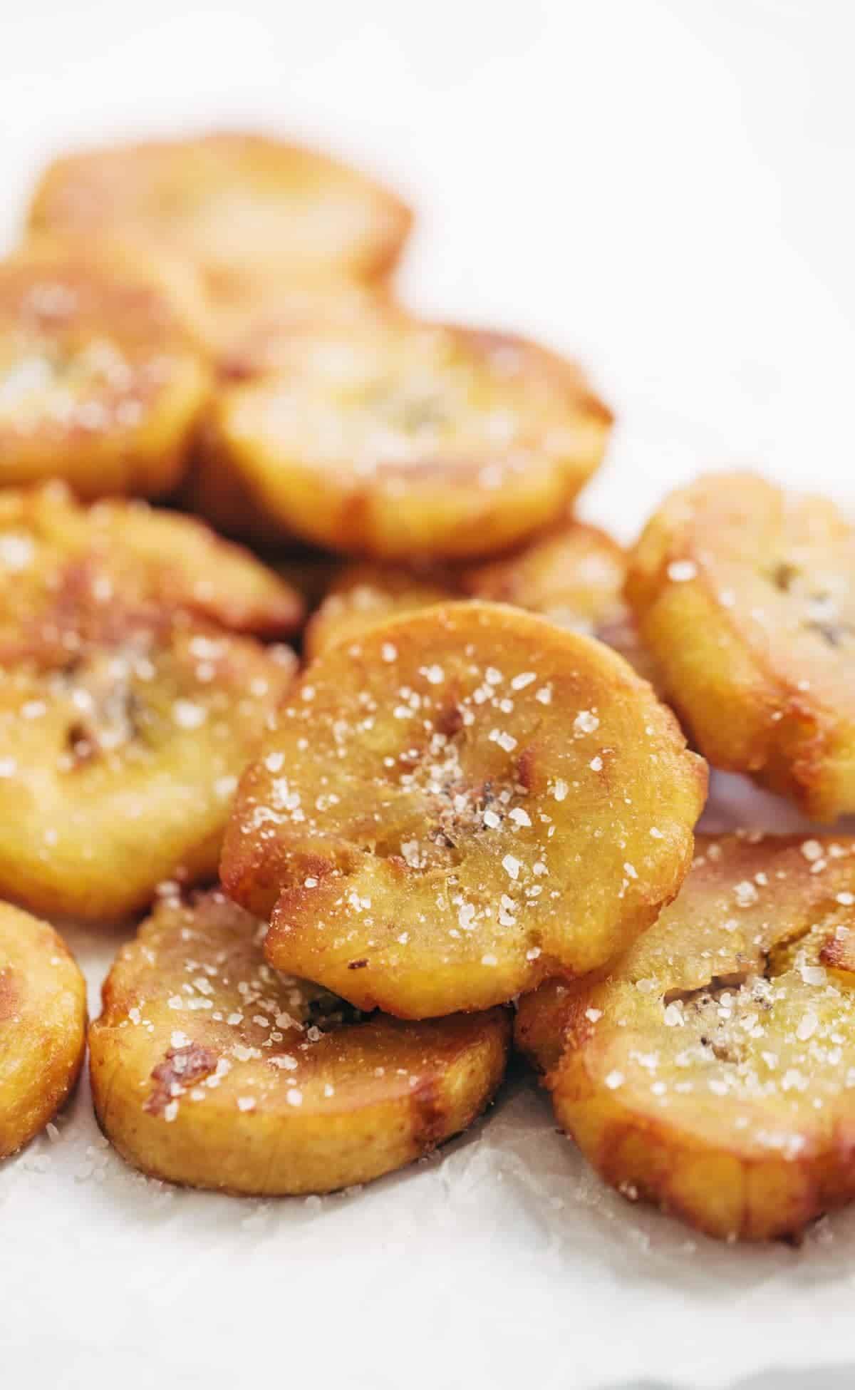 Crispy Salted Tostones - super easy recipe for golden brown bites of perfection with just one ingredient: PLANTAINS! video demo in the post. | pinchofyum.com