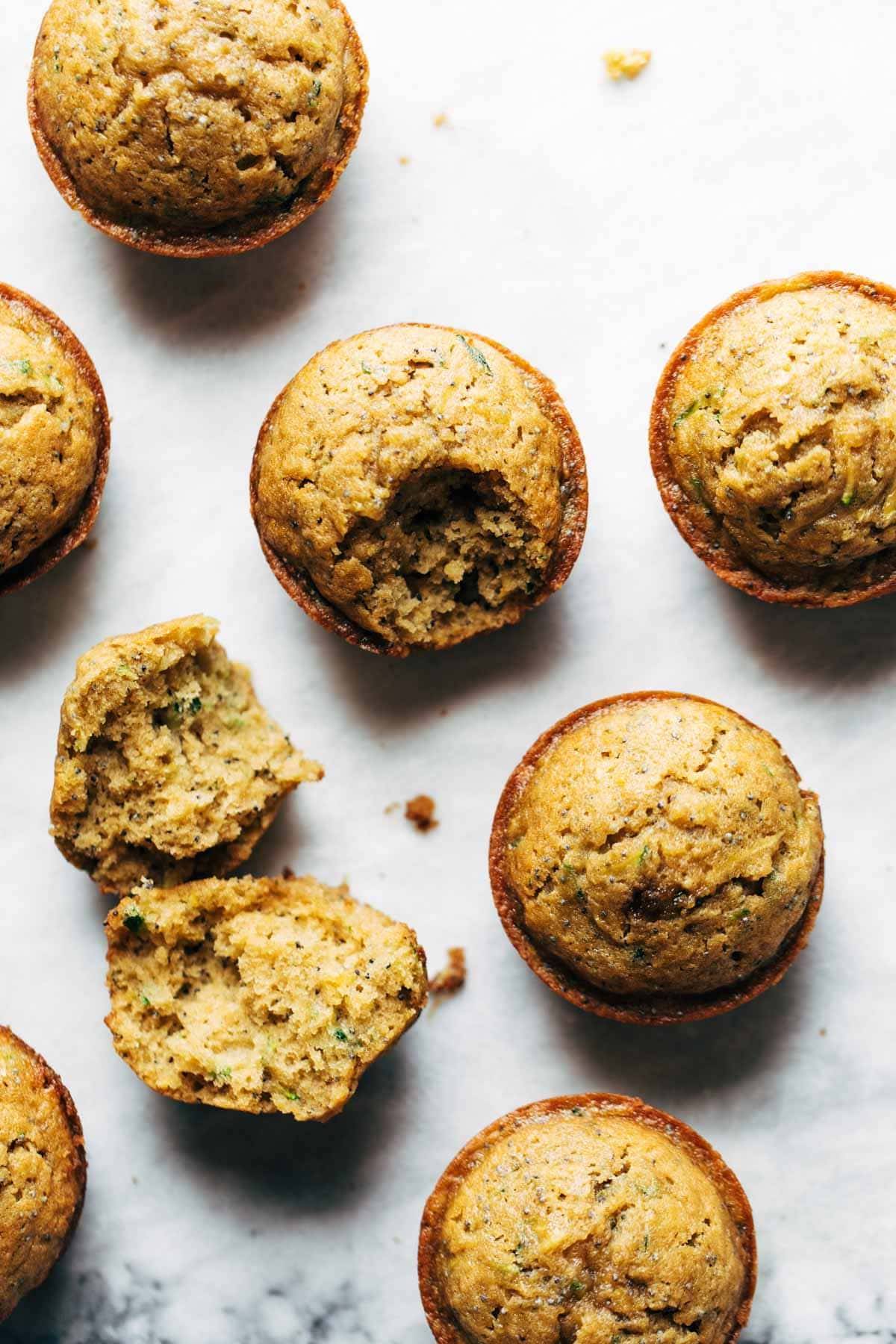 Lemon poppyseed zucchini muffins with bite taken out.