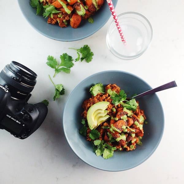 Camera and food in a blue bowl.