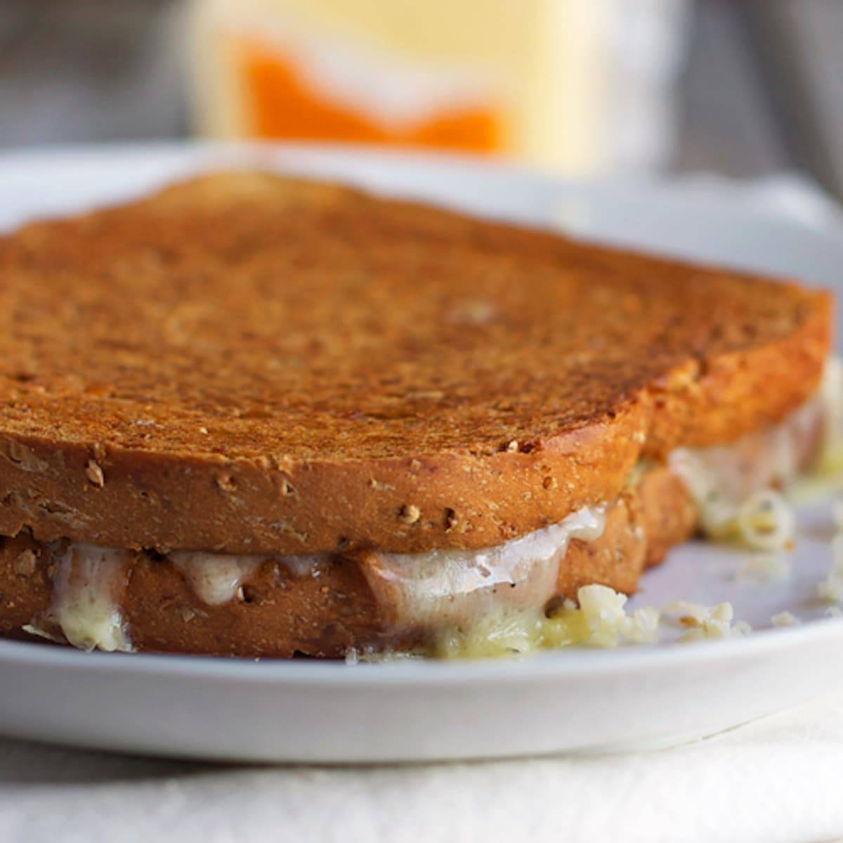 Three cheese grilled cheese on a plate.
